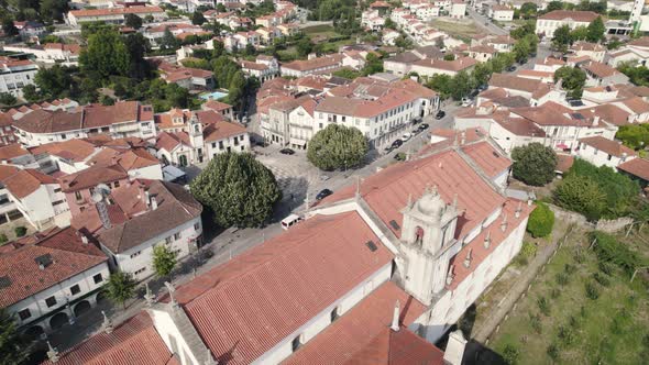 Aerial pan shot overlooking at the traffic on Avenida 25 de Abril, parish townscape of Arouca