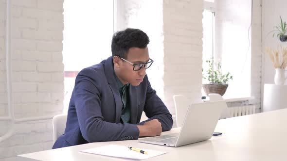 Businessman Reading Email on Laptop