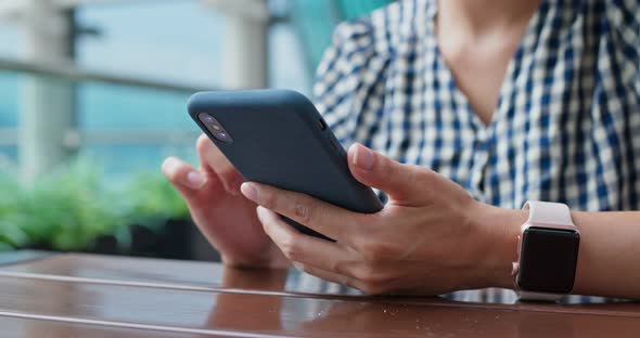 Woman use of mobile phone at outdoor restaurant 