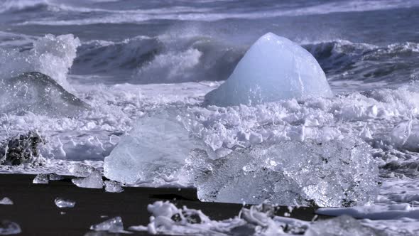 Ice From a Glacier Washing By Atlantic Ocean Waves on a Black Diamond Beach in Iceland. Climate