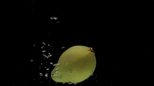 Slow Motion One Pear Falling Into Transparent Water on Black Background