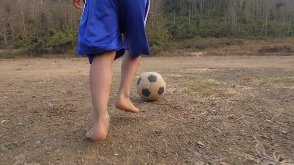 Rural Boy Running With A Soccer Ball