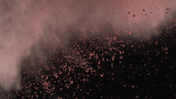 Powder exploding against black background. Slow Motion. Unedited version included.