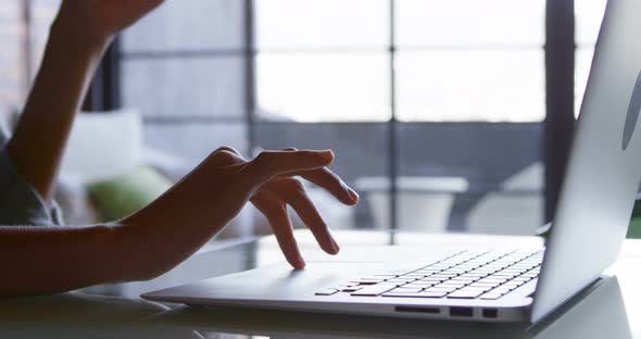 Woman using laptop at home 4k