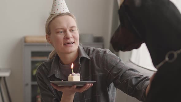 Dog Mom Blowing Candle on Cake