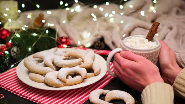 Woman Holding Cup of Cocoa with Marshmallow and Traditional Vanillekipferl Vanilla Kipferl Cookies