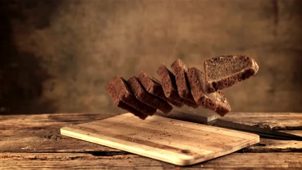 Super Slow Motion on the Cutting Board Fall Pieces of Bread