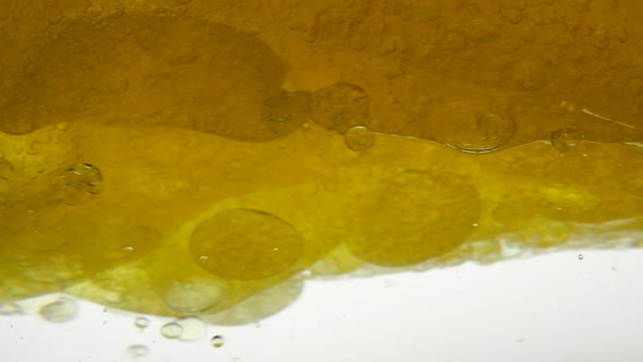Sunflower Yellow Oil Is Mixed with Water, Not Dissolve. Bubbles Air Bulbs Float in Liquids Creating