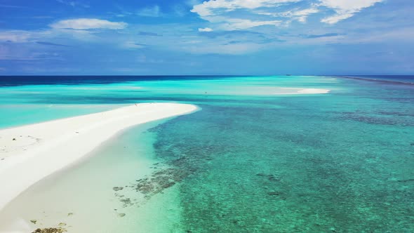 Daytime overhead abstract view of a white sand paradise beach and blue water background