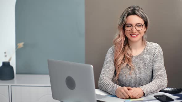 Portrait of Happy Business Female Posing at Modern Workplace with Laptop