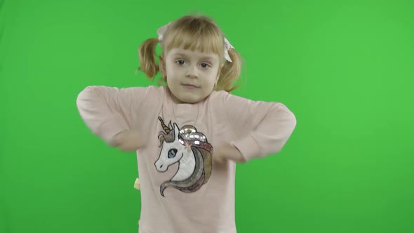 Girl in Unicorn Sweatshirt Dancing. Happy Four Years Old Child. Chroma Key