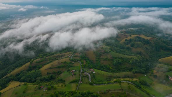 Aerial time lapse of fog over hills after rain