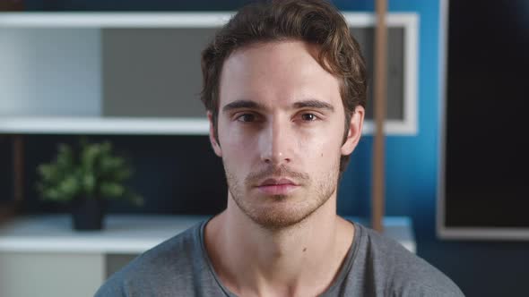 Confident Young Adult European Man Looking at Camera Standing at Home Office. Close Up Portrait of