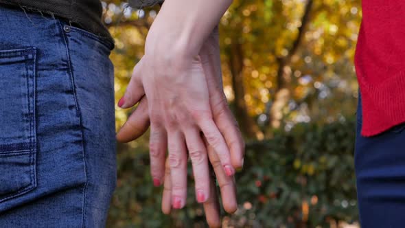 Interracial love symbol: black man's hand holding white woman's hand