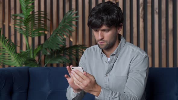 Happy Excited Man Winner Sport Fan Looking at Mobile Phone Screen Celebrating Online App Game Win