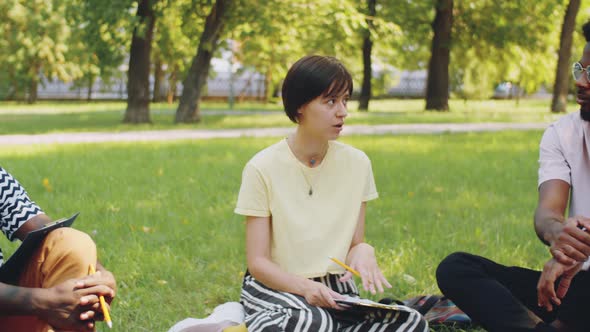 Multiethnic College Students Talking at Lesson in Park