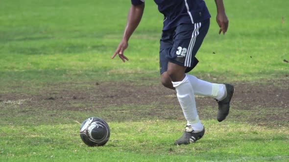 A man playing soccer on a grassy field