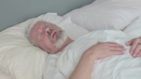 Peaceful Old Man Sleeping in Bed