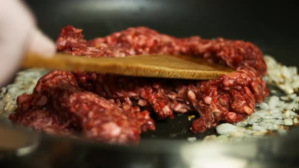 Ground Beef and Chopped Onion and Garlic Cooking on a Frying Pan