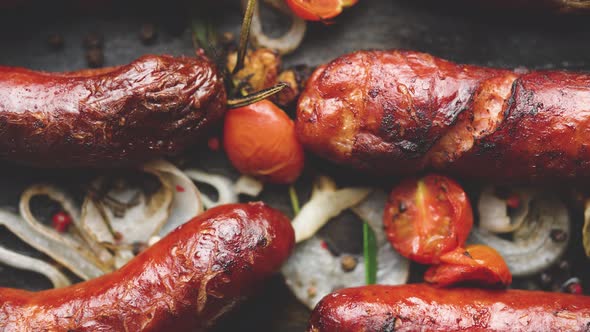 Tasty Grilled Homemade Rosemary Sausages Placed on Iron Frying Tray Over Rustic Dark Stone Table