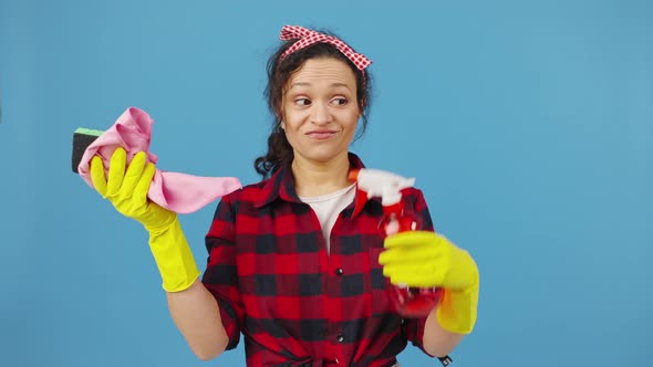 Woman Housewife Throwing Away Cleaning Rags and Detergents and Gesturing Thumbs Up Smiling to Camera