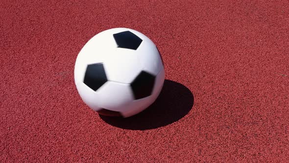 Football ball spinning on red field