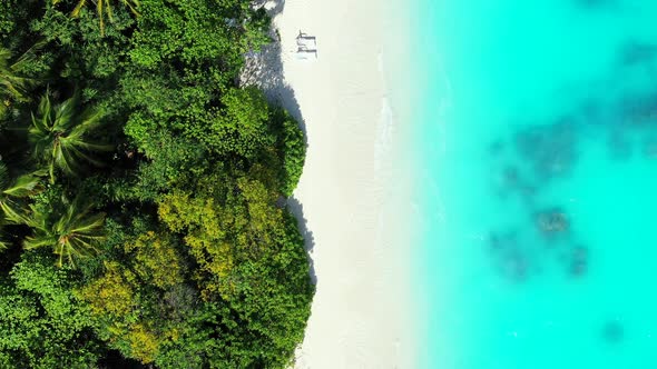 Tropical drone island view of a paradise sunny white sand beach and turquoise sea background in best