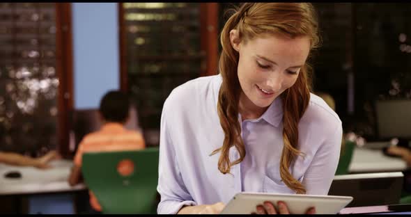 Teacher using digital tablet in classroom