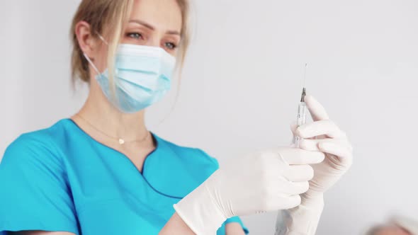 Nurse Preparing a Syringe for an Injection Medium Closeup Indoors Hospital Healthcare Concept