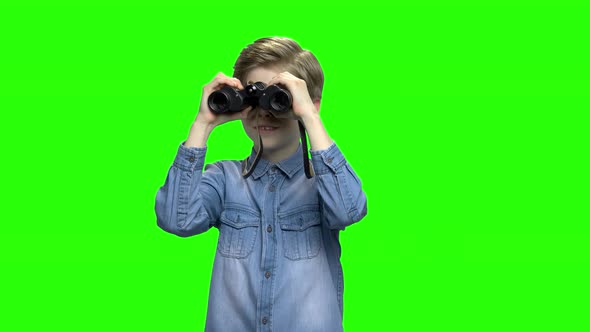 Little Boy in Denim Jacket Observing Locations Using Binoculars