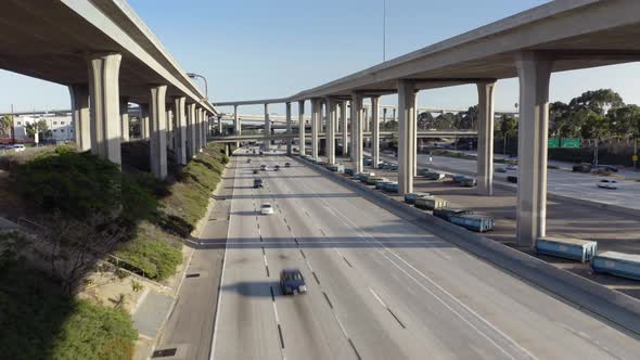 Cars Drive the Freeway. Camera Moves Up From the Ground Traffic To the Second Level of the Overpass