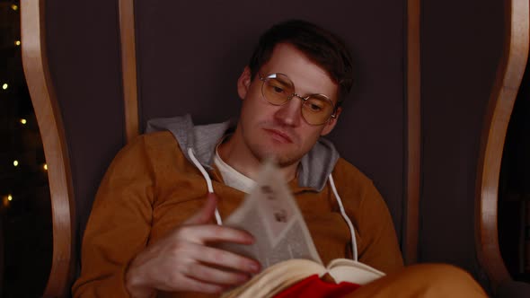 Young Man in Glasses Reading Book