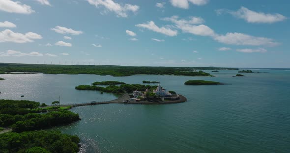 Aerial View of an Indian Temple in the Indian Ocean Lagoon Amidst Lush Green Vegetation Against the