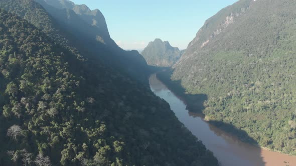 Aerial: flying over Nam Ou River Nong Khiaw Muang Ngoi Laos, scenic valley