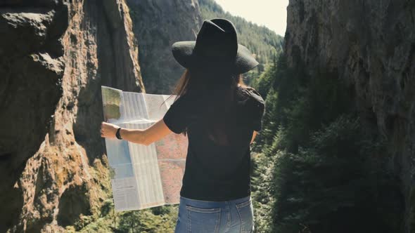 Adorable Girl with Touristic Map in Trigrad, Shiroka Laka, Bulgaria. Happy Women Enjoy Bulgarian