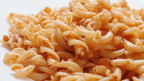 Italian Girandole corkscrew shaped pasta in tomato sauce prepared  food 4K 2160p 30fps UltraHD tilti