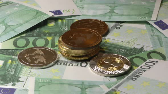 Ripple Coins Rotating on Bills of 100 Euro Banknotes. Worldwide Virtual Internet Cryptocurrency.