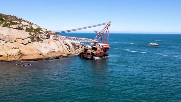 Aerial view of shipwreck crane barge is off the coast of Sandy Bay.