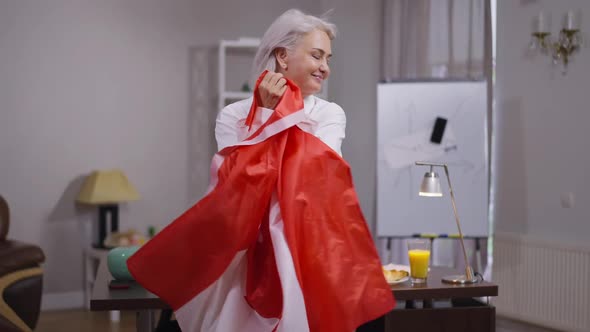 Portrait of Happy Middle Aged Woman Posing with Canadian Flag in Office Indoors