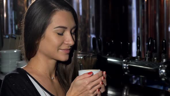 Beautiful Young Woman Smiling, Looking Away Dreamily, Enjoying Her Coffee