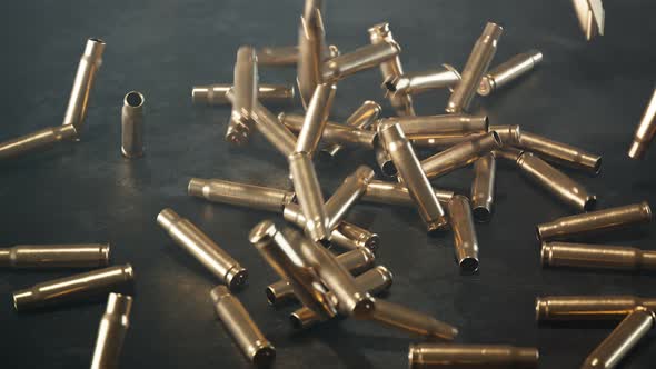 Empty shells falling down on the floor. Gun ammunition. Metal bullets. Ammo.