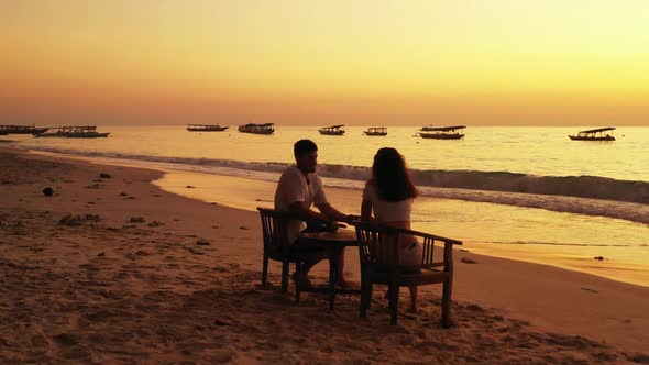 Romantic couple suntan on beautiful shore beach voyage by clear water with white sandy background of