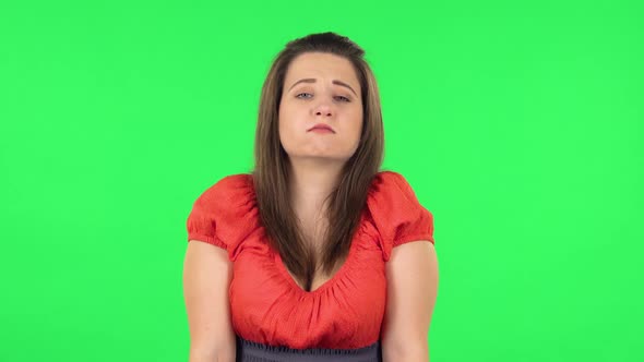 Portrait of Upset Girl Shrugging and Shaking Her Head Negatively . Green Screen