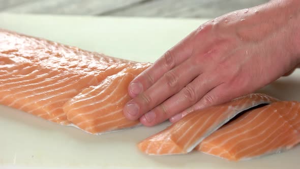 Hands Cutting Fresh Salmon