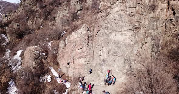 A Group of People are Engaged in Rock Climbing