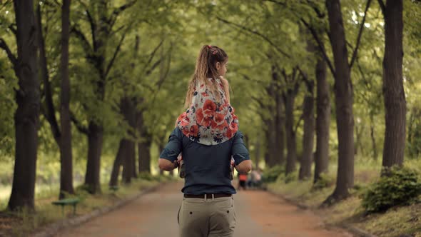 Daughter Sitting On Father Neck. Cute Little Kid Having Fun. Carefree Dad With Preschool Daughter.