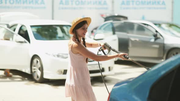 Brunette From a Highpressure Hose Washes the Car