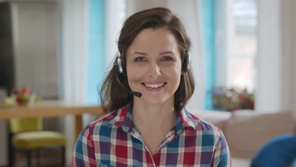 Happy Woman In Headset Making Video Call Communicating with Client Working From Home