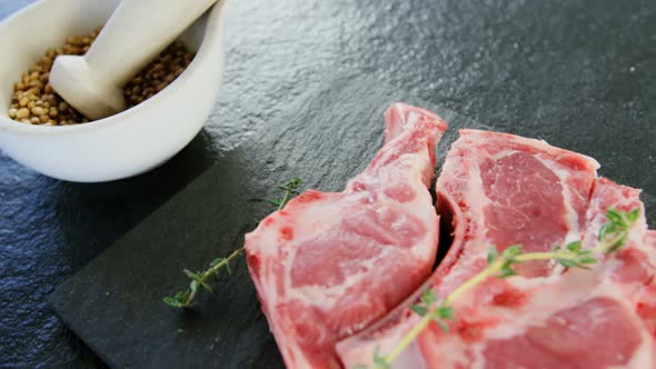 Rib chop, spice and herbs on concrete background