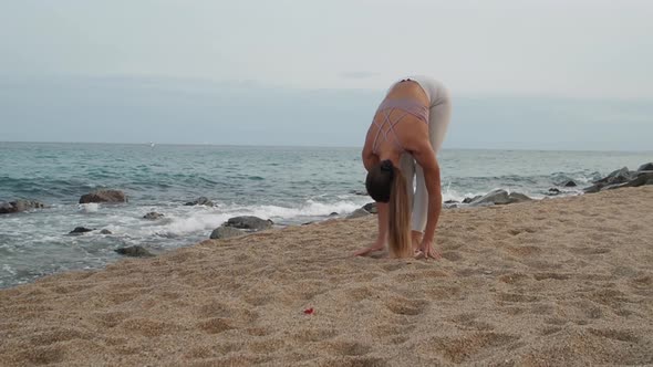 Latin Woman Practicing Yoga in the Sea During a Sunset